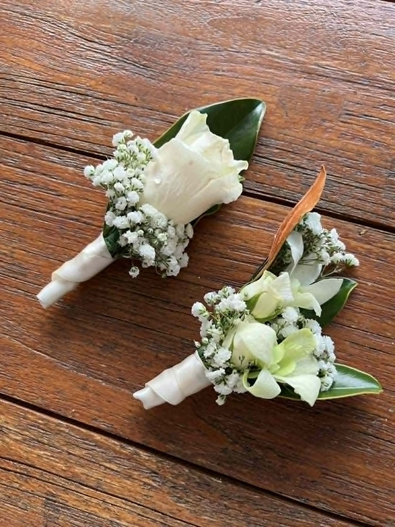 Handmade white rose and orchid buttonholes