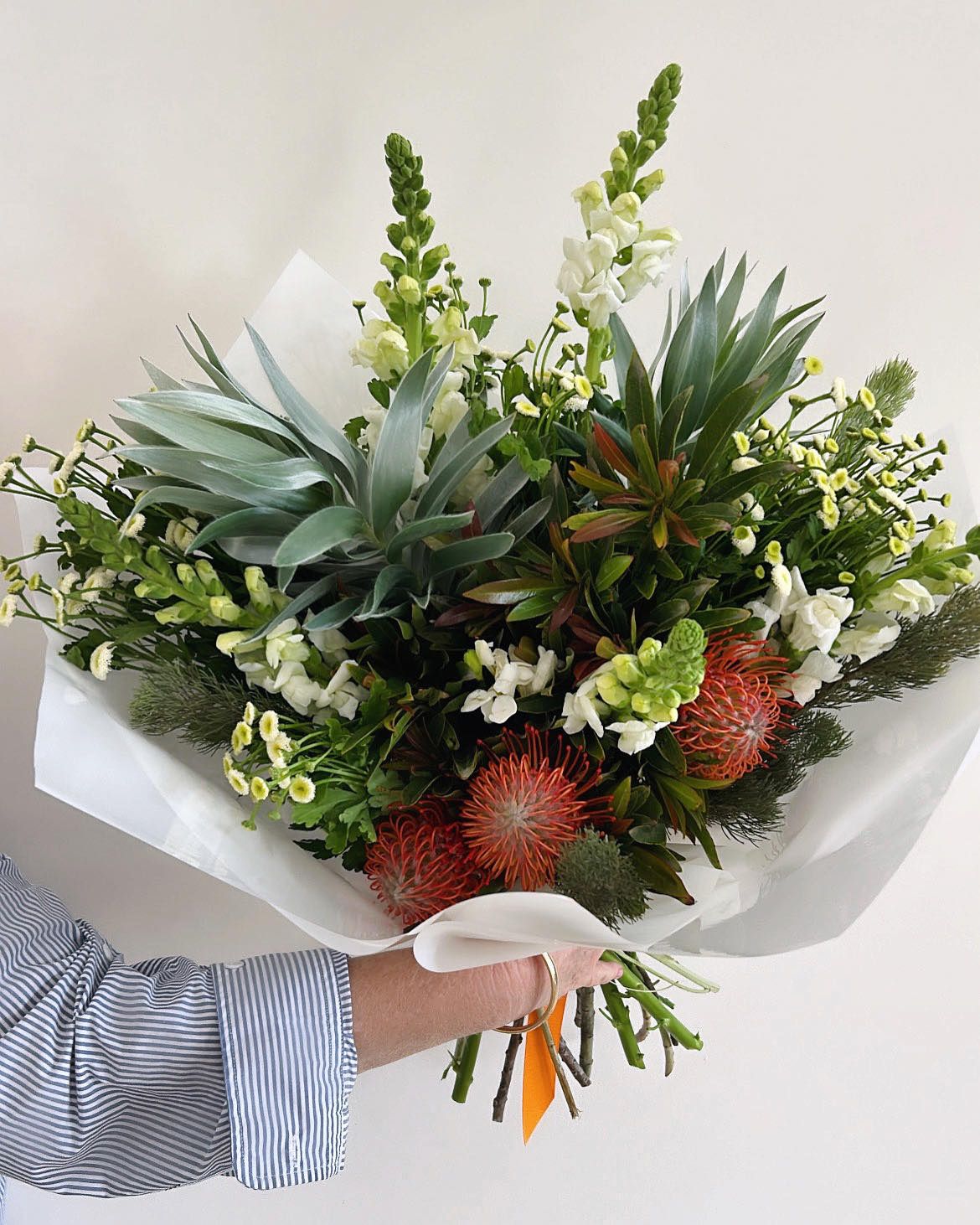 Large seasonal bouquet with white snapdragons and pincushion protea